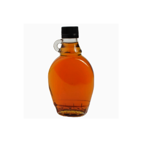 Thick, rich, golden-brown coconut nectar syrup flowing in a stream, highlighting its natural texture and glossy sheen.